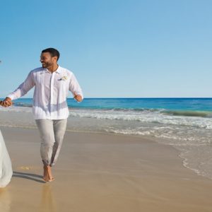 Beach Weddings Abroad Dominican Republic Weddings Bride And Groom Running On Beach